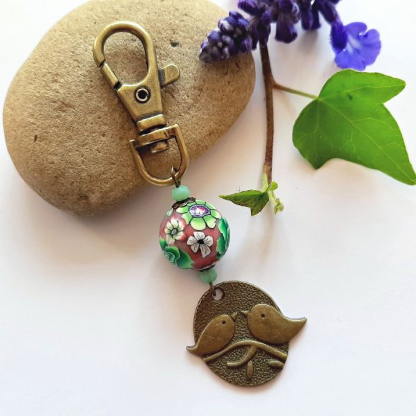 n&oslash;glering medalje duo af fugle bronze farve og perle udformet blomstermotiv gr&oslash;n og vinb&aelig;rmulticolour