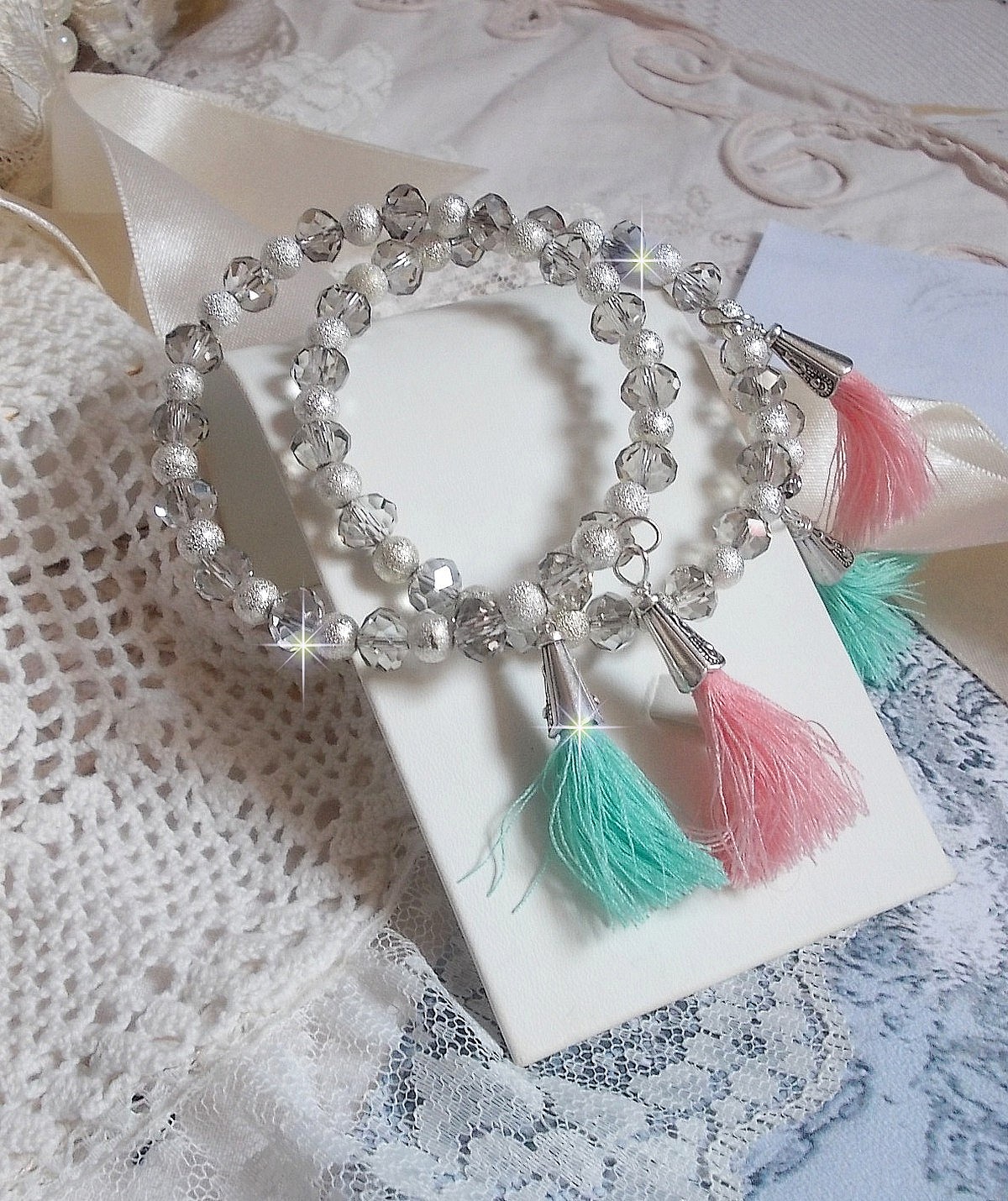 Bracelets Cristalline Eclat avec doubles bracelets aux perles Stardust Argent&eacute;es effet paillet&eacute;, perles rondes facett&eacute;es en verre et pompons couleur Rose et Menthe pour un style contemporain