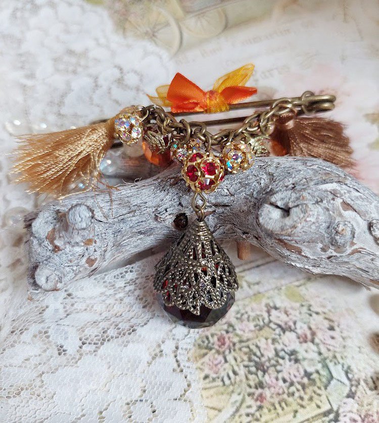 Broche Méline des Bois épingle créée avec rondes strass, pompons, gouttes verre, chaîne et boule de bohème en verre