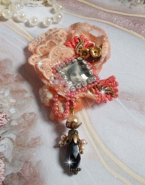 Rustik Rose broche skabt med en cabochon, der forestiller en smilende pige, orange rhinestone og Rose blonder, krystaller, glasperler og diverse tilbeh&oslash;r