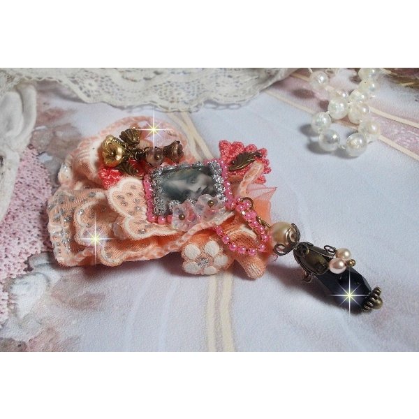 Rustik Rose broche skabt med en cabochon, der forestiller en smilende pige, orange rhinestone og Rose blonder, krystaller, glasperler og diverse tilbeh&oslash;r