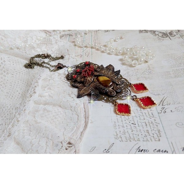 Pendentif M&eacute;lodie avec un cabochon &OElig;il de tigre orn&eacute; de perles en Jade Rouge vein&eacute; de Noir sur fleurs 5 p&eacute;tales et estampes mont&eacute;s sur une cha&icirc;ne bronze. Les pendants sont en r&eacute;sine &eacute;poxy Rouge