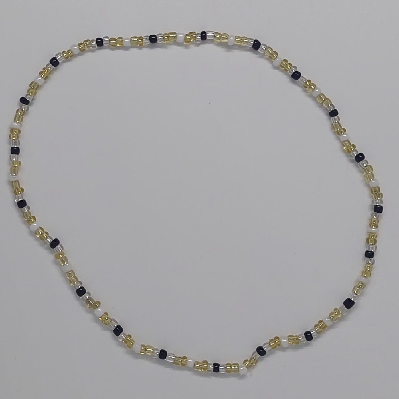 Ras du cou &eacute;lastique dor&eacute; et noir en perles de rocaille